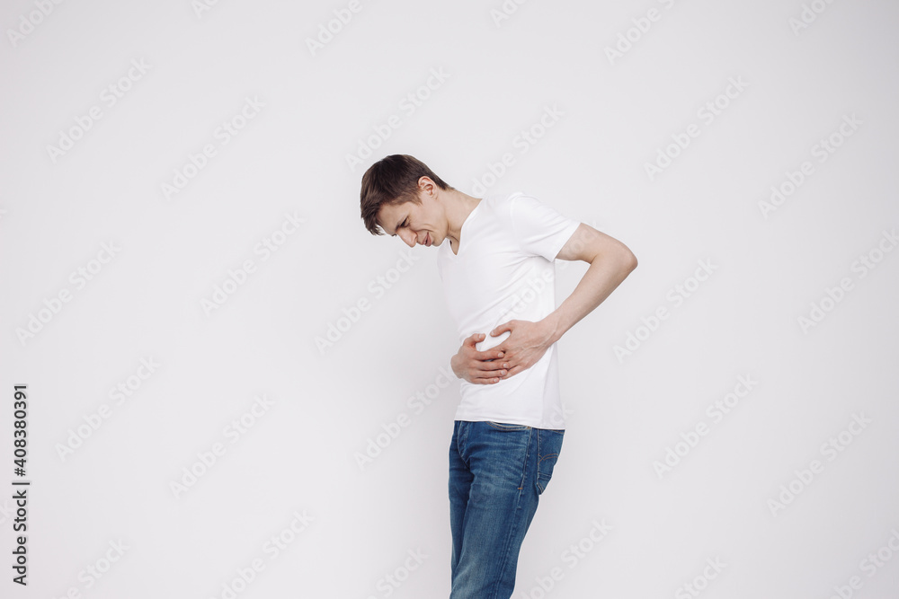 Portrait of man showing abdominal pain in a white t-shirt isolated on white background. Portrait of man showing abdominal pain in a white t-shirt isolated on white background.