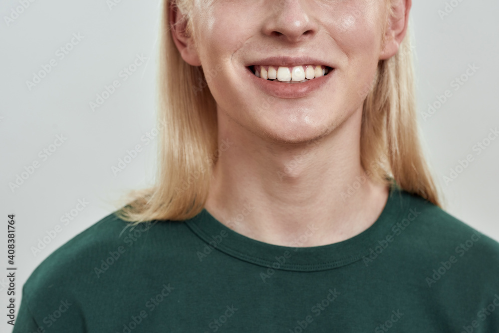 Happy young caucasian man with long fair hair smiling Happy young caucasian man with long fair hair smiling