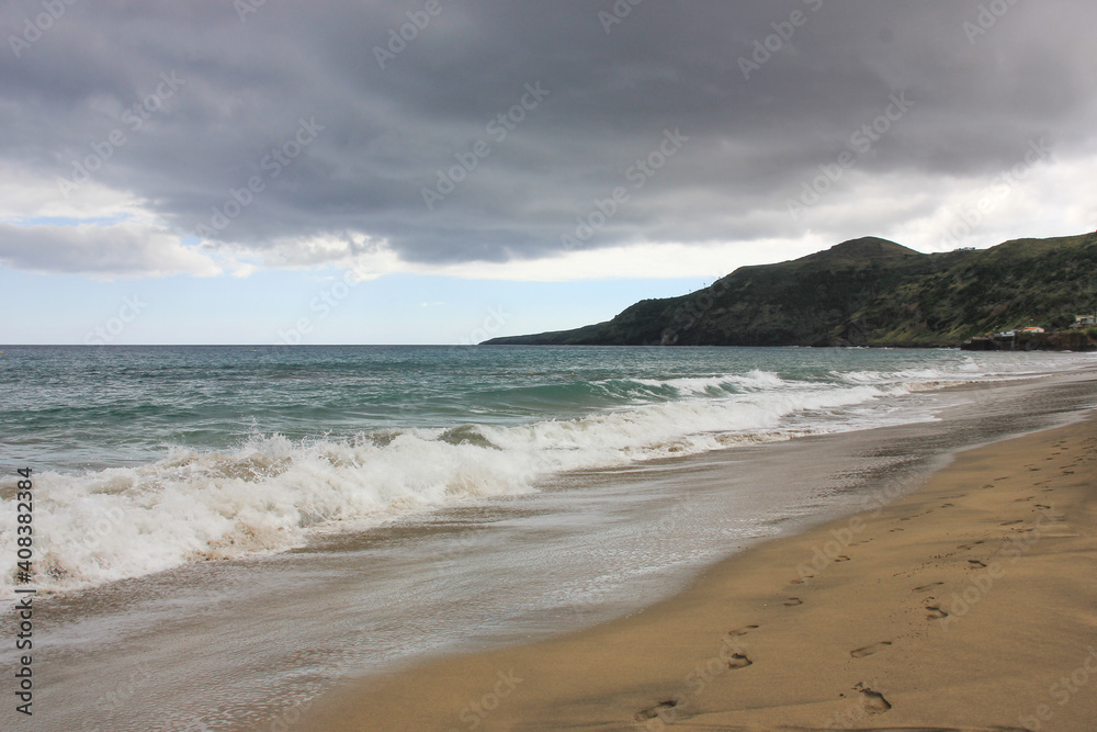Breaking wave, light sand, Azores, Santa Maria island.