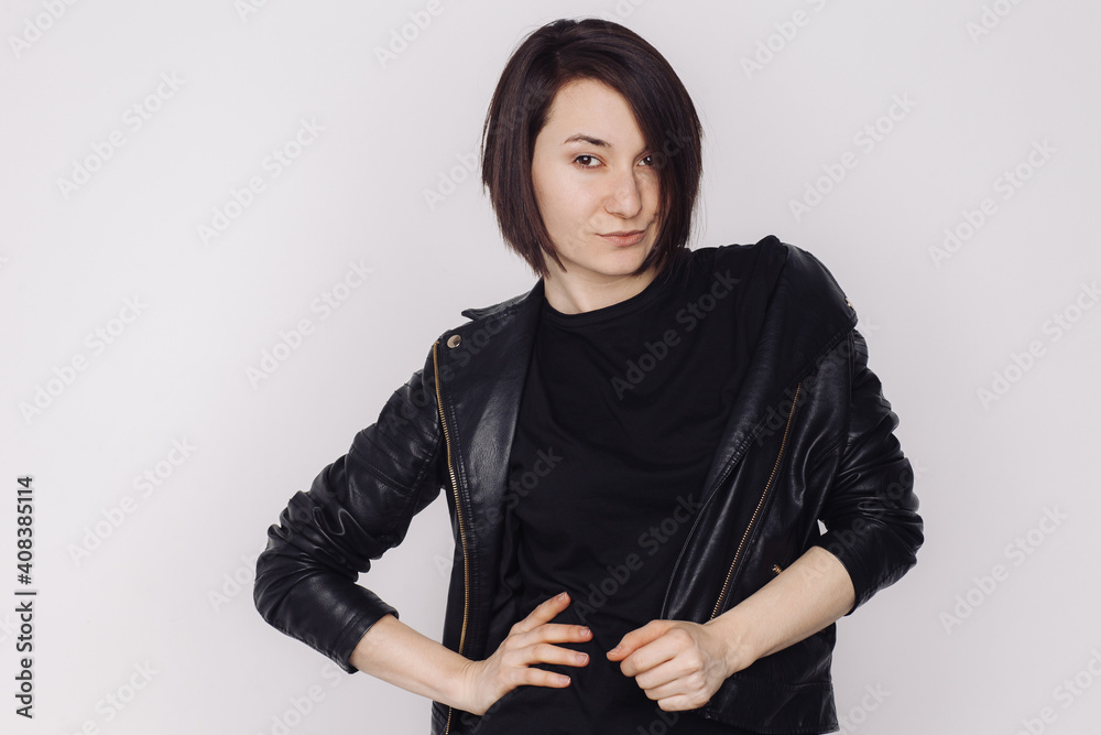 Portrait of smiling female in a black sweater and black jacket isolated on white background.