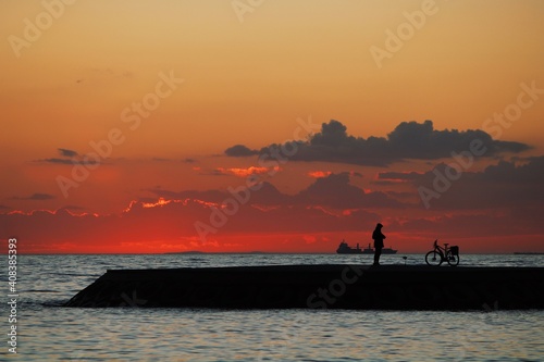 silhouette of a cyclist on the beach