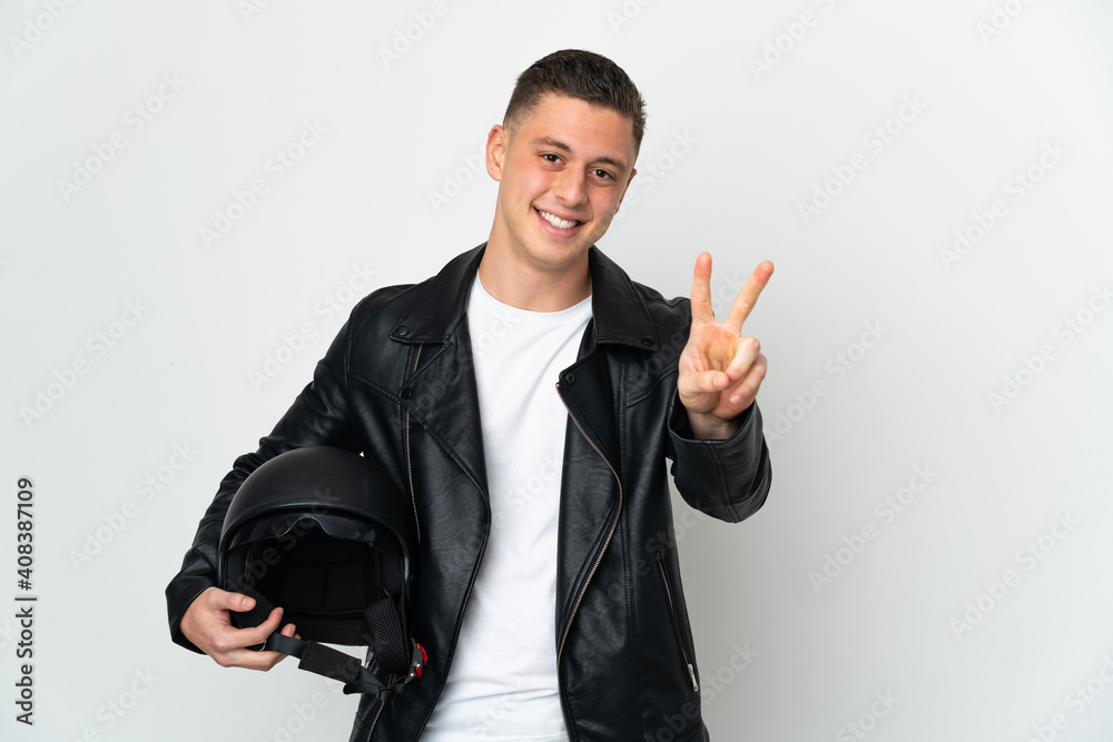 Caucasian man with a motorcycle helmet isolated on white background smiling and showing victory sign Caucasian man with a motorcycle helmet isolated on white background smiling and showing victory sign
