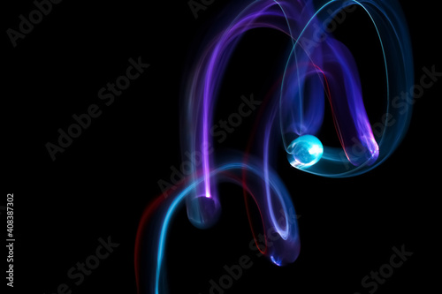 Long exposure colorful lights abstract texture background. Colorful lights drawing patterns on black background. Colored wallpaper.