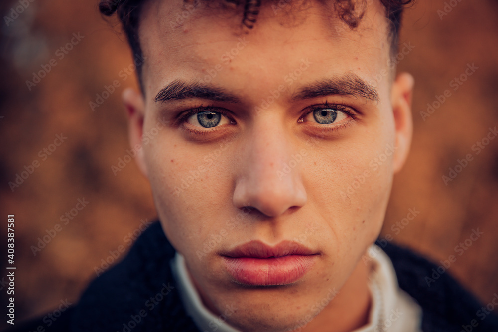 Young man with blue eyes in autumn forest Young man with blue eyes in autumn forest