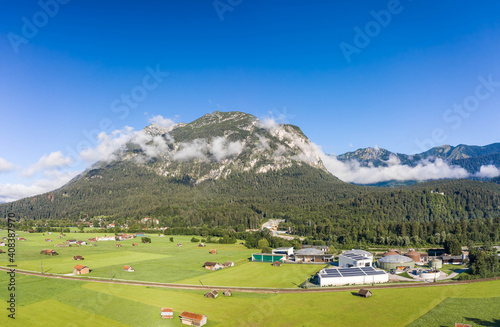 Aerial of green hill with fog in Garmisch-Partenkirchen German Village in Summer