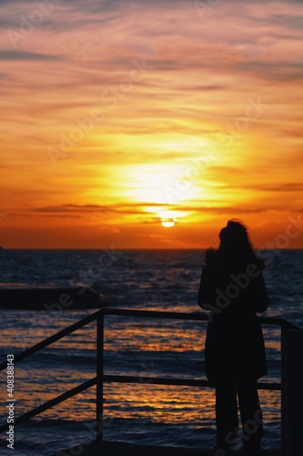 silhouette of a person on a pier