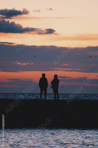 couple walking on the beach at sunset