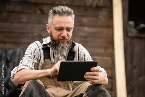 Portrait of carpenter using digital tablet during break photo