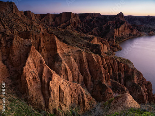 Burujon Canyon are spectacular clay cut that have been formed by wind erosion and the Tagus river, inside the reservoir Castrejon, which affords greater beauty to this place and becomes a refuge for many species of birds, Toledo, Castile La Mancha, Spain. photo