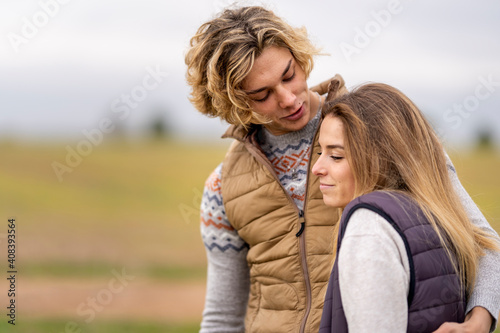 Brother and sister embracing outdoors during hike