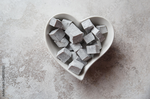 Turkish delight. Turkish sweets in a heart-shaped plate. lokum.Grey colour. Valentine's day concept. Background image for design