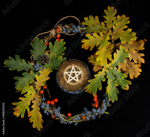 Photography Wiccan pentacle with dried leafs and wreath