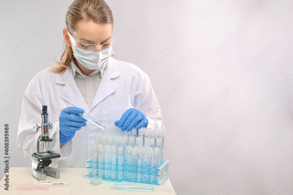 A doctor or a vaccinologist in a laboratory makes a vaccine or works with a virus. Concept of vaccinating people against coronavirus A doctor or a vaccinologist in a laboratory makes a vaccine or works with a virus. Concept of vaccinating people against coronavirus