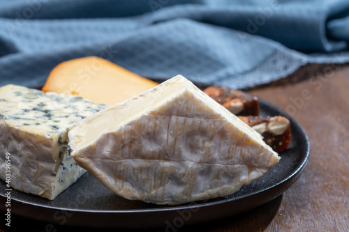 Cheese collection, blue cheese, camembert, brie served as dessert with fig almonds bread photo