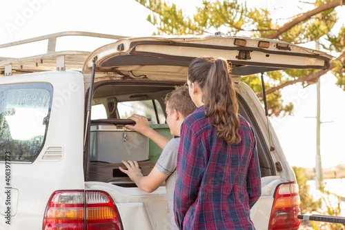 Teenagers with four-wheel-drive and car fridge photo