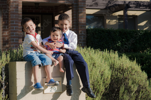 Mixed race brothers play together in the yard of their suburban Sydney home