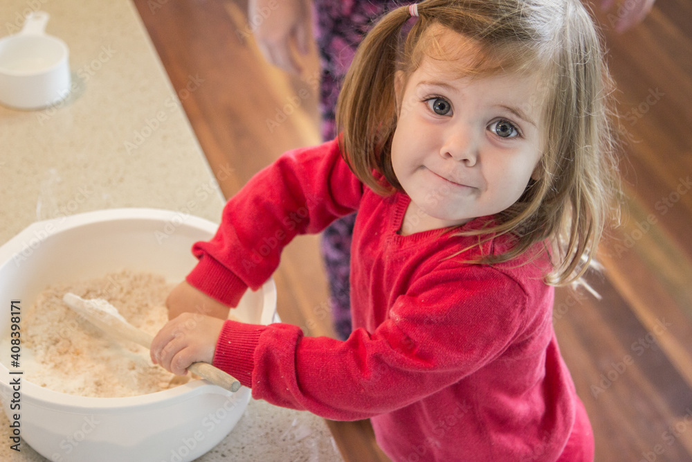 Little girl helping cook ANZAC biscuits Little girl helping cook ANZAC biscuits