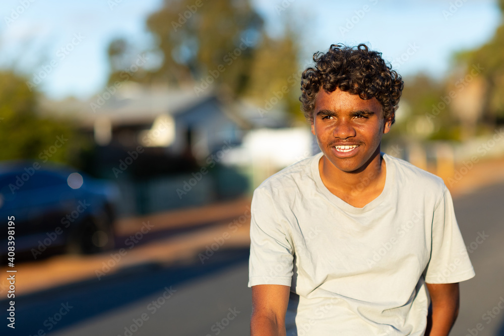 head and shoulders of aboriginal boy outdoors in town head and shoulders of aboriginal boy outdoors in town