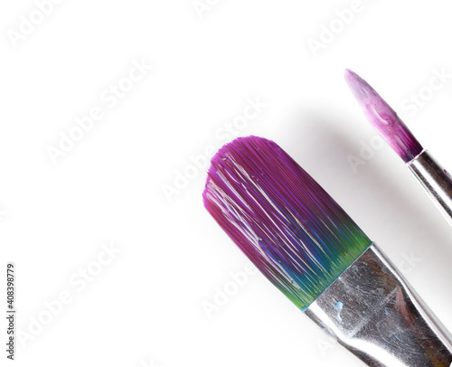 two brushes wide and narrow with shaddows on a white background. photo