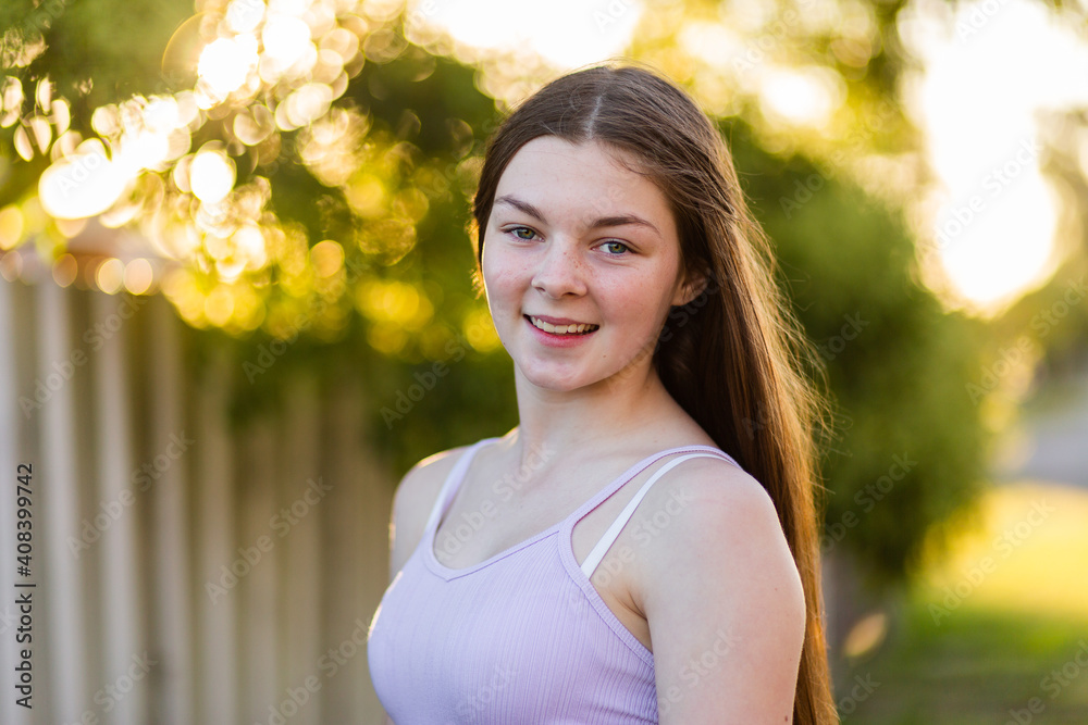 Close up portrait of a fourteen year old brunette girl with bokeh light in the background Close up portrait of a fourteen year old brunette girl with bokeh light in the background