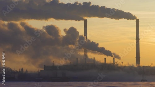 Plant pipes pollute atmosphere. Industrial factory pollution, smokestack exhaust gases. Industry zone, thick smoke plumes. Climate change, ecology global warming.