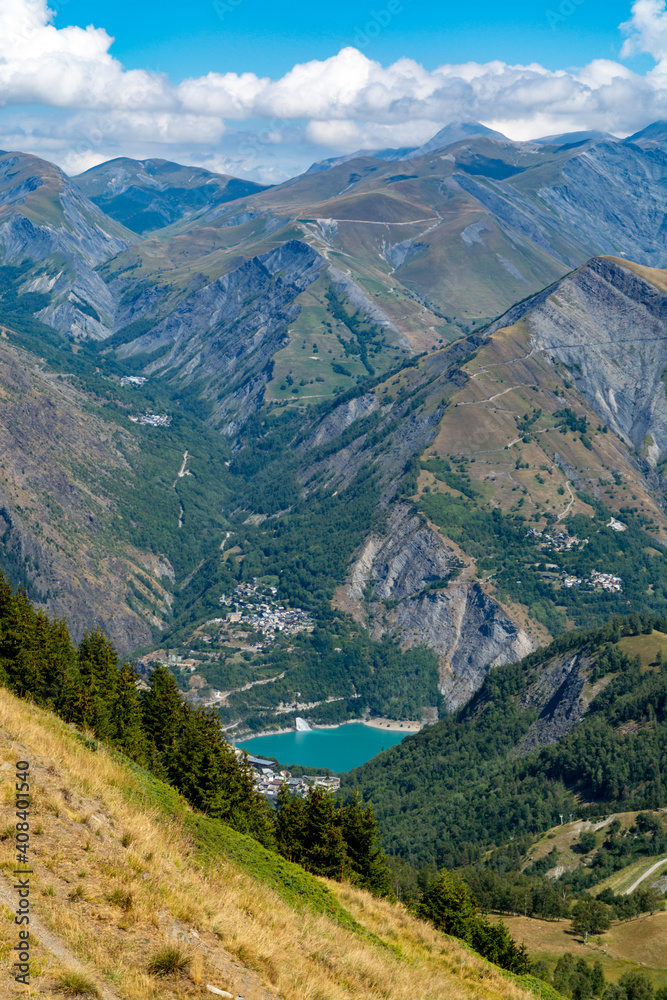 Fototapeta premium Hiking near ski station Les deux Alpes and view on Alpine mountains peaks in summer, Isere, France