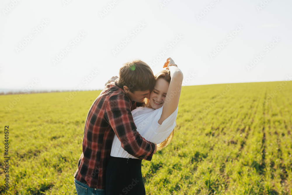 Smiling man and woman having fun in the countryside on the green field. Smiling man and woman having fun in the countryside on the green field.