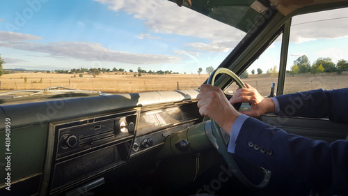 Man driving a classic car (1968 Holden kingswood HK) in the country photo