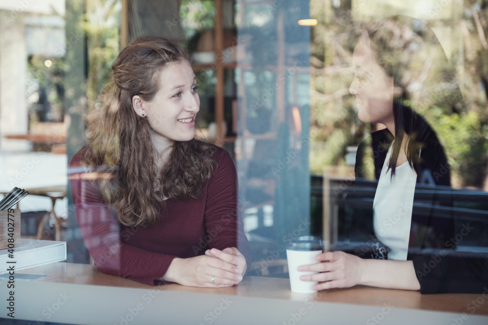 Young women talking at coffee shop Young women talking at coffee shop