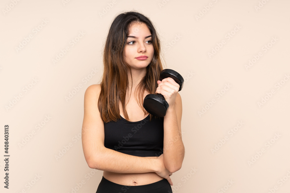 Young sport woman making weightlifting isolated on beige background thinking an idea Young sport woman making weightlifting isolated on beige background thinking an idea