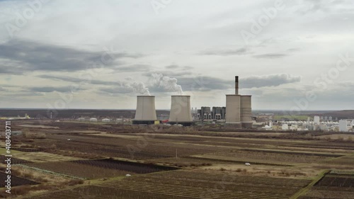 Power plant cooling towers steam and smoke rising drone footage photo