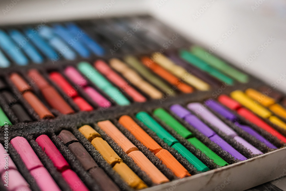 Multicolored artists soft pastels, chalks, crayons in the box. Spectrum of colors. Background. Selective focus. Multicolored artists soft pastels, chalks, crayons in the box. Spectrum of colors. Background. Selective focus.