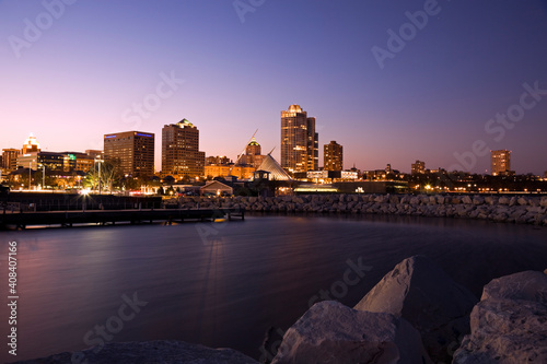 USA, Wisconsin, Milwaukee skyline across lake at dusk photo