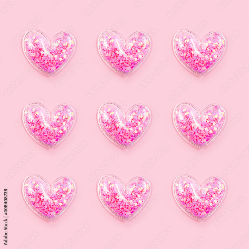Hearts with glitter on pastel pink background in a row. Top view ...
