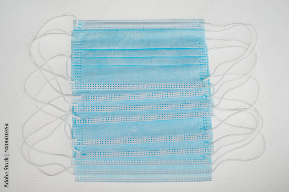 Surgeon masks to protect from Covid-19, worldwide pandemic in 2020 and 2021, blue coloured, empty copy space for text, isolated on a white background Surgeon masks to protect from Covid-19, worldwide pandemic in 2020 and 2021, blue coloured, empty copy space for text, isolated on a white background
