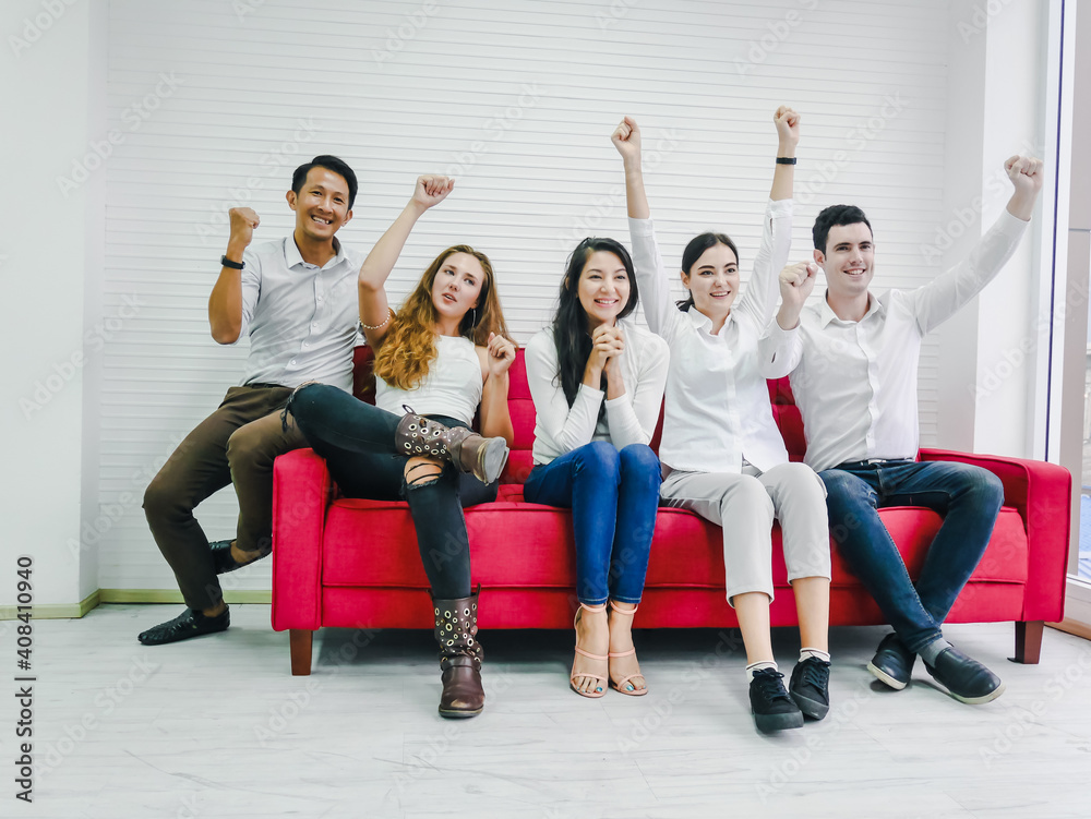 Friends cheering on sports from the television in the room, the mood of the winning supporters, everyone was happy Friends cheering on sports from the television in the room, the mood of the winning supporters, everyone was happy