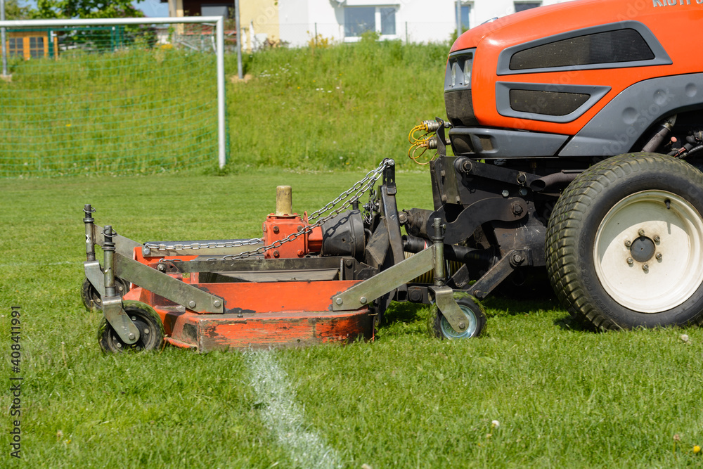 Sports Facility Is Mowed Lawn Tractor - Lawn Maintenance Sports Facility Is Mowed Lawn Tractor - Lawn Maintenance