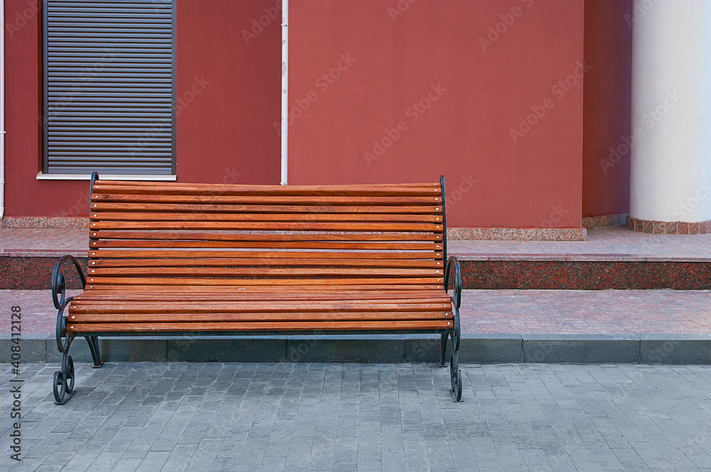 Empty bench in the street outside. Urban background. Rest and relaxation Empty bench in the street outside. Urban background. Rest and relaxation