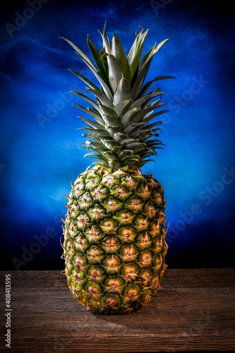 Big pineapple with its leaves on a barn wood board
