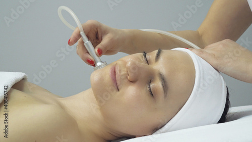 Face of woman having oxygen facial treatment in beauty salon photo