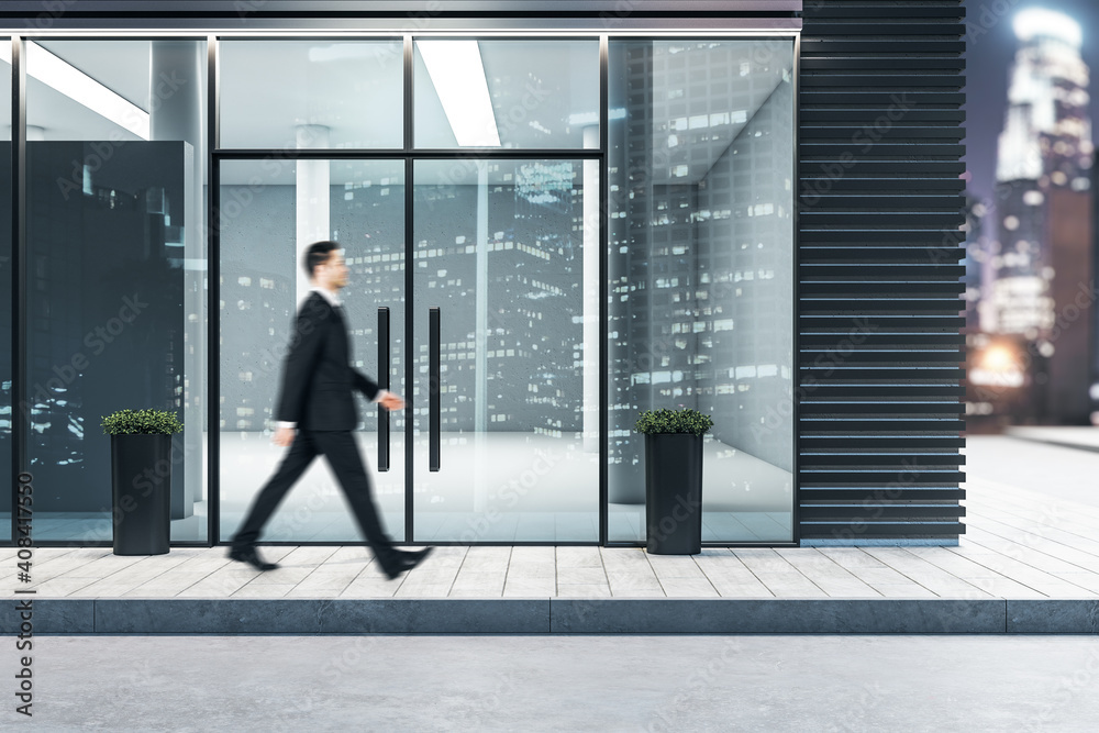 Businessman walking near glass entrance in modern business center Businessman walking near glass entrance in modern business center