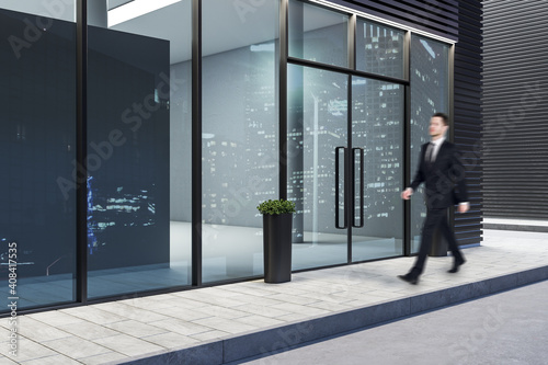 Businessman walking near modern building. © Who is Danny