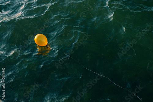 yellow balloon in the ocean