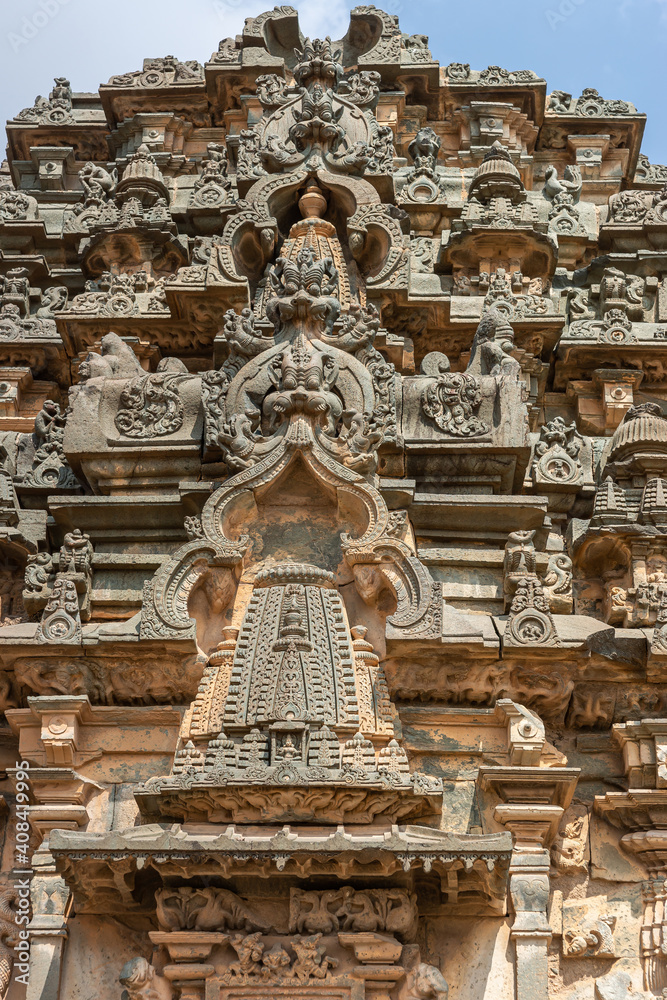 Lakkundi, Karnataka, India - November 6, 2013: Kasivisvesvara Temple. Extensive brown-gray stone sculptures on side of vimanam above main entrance. 