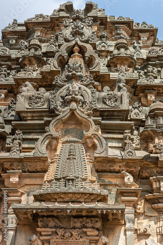 Lakkundi, Karnataka, India - November 6, 2013: Kasivisvesvara Temple. Extensive brown-gray stone sculptures on side of vimanam above main entrance. 