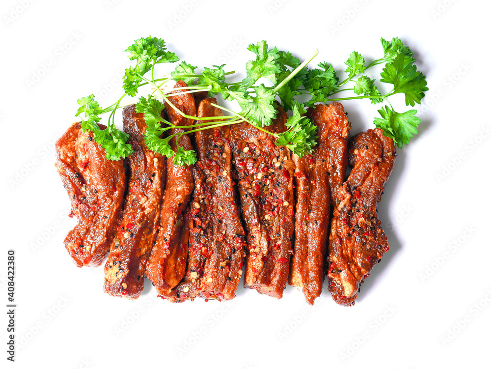 Uncooked raw marinated style pork belly chops on a white background with coriander leafs. Korean style marinade over the slices. Meat industry product Uncooked raw marinated style pork belly chops on a white background with coriander leafs. Korean style marinade over the slices. Meat industry product
