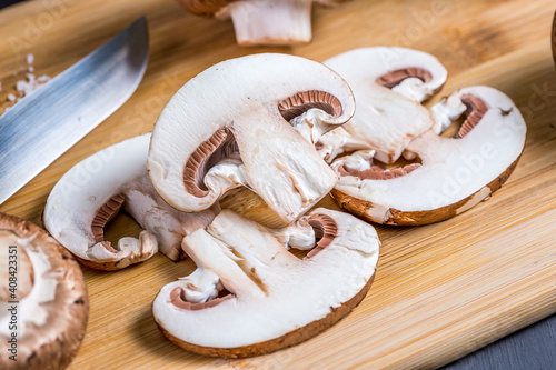 Close-up of a slice of edible mushroom champignons on a cutting board