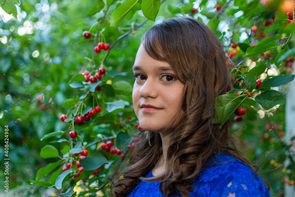 Portait of cute teen girl with makeup posing in cherry garden Portait of cute teen girl with makeup posing in cherry garden