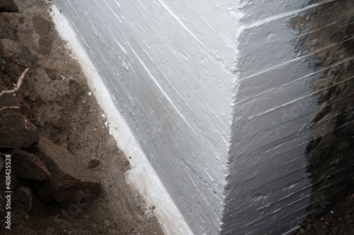 Waterproofing foundation of an old house.