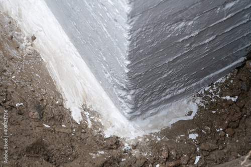 Waterproofing foundation of an old house.